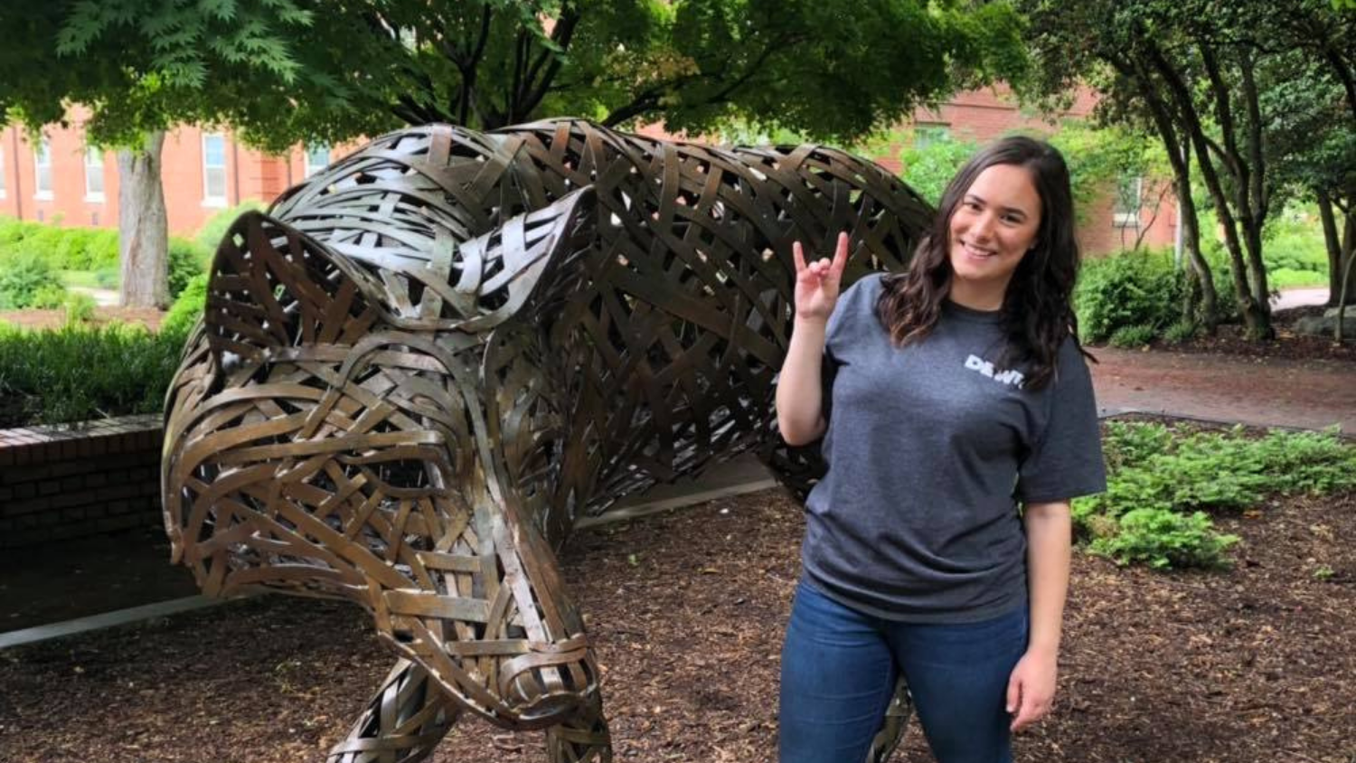 Student Photo next to Wolf Statue - Alumni Spotlight: Mawadda Almarsi -Forest Biomaterials NC State University