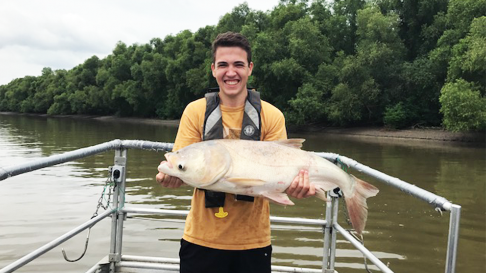 Jacob Veilleux Holding a Fish - Fisheries, Wildlife and Conservation Biology - Forestry and Environmental Resources NC State University