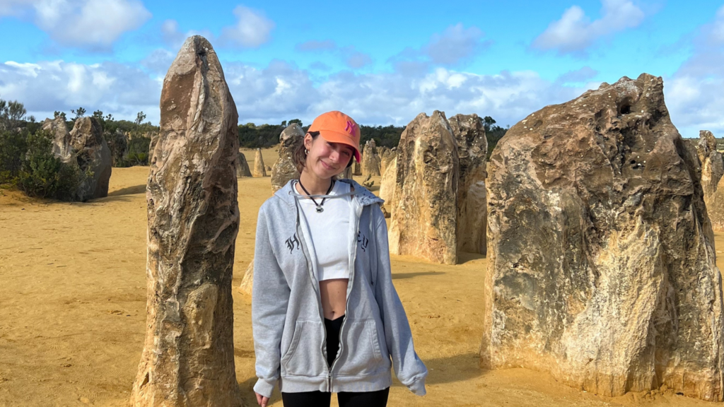 Tatiana standing in a desert with large vertical boulders scattered around - Tatiana Frontera’s Semester in Australia - Forestry and Environmental Resources at NC State University