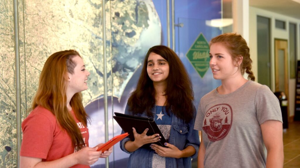 Three students conversing with each other. - Degree Programs - Professional Development - Forestry and Environmental Resources NC State University