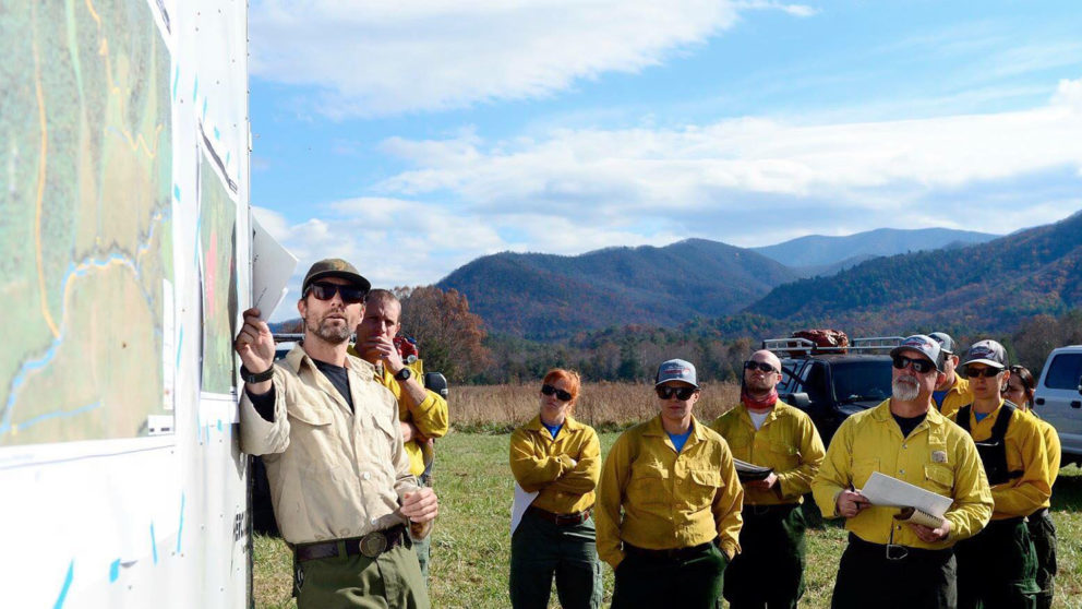 Fire managers gather around a map before a prescribed fire in the Appalachians