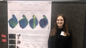Megan Coffer stands with her research poster