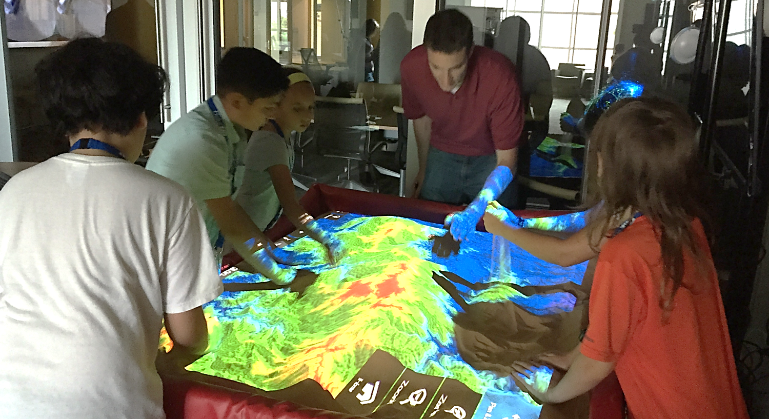 A photo of visiting students from a Duke Talent Identification Program (TIP) workshop at the North Carolina State University Center for Geospatial Analytics