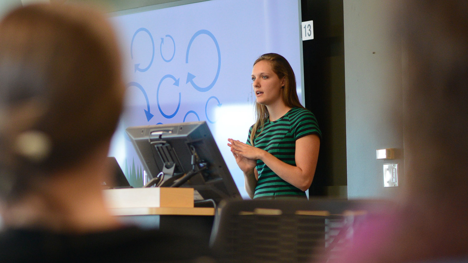 A photo of a woman giving a presentation at the North Carolina State University Center for Geospatial Analytics