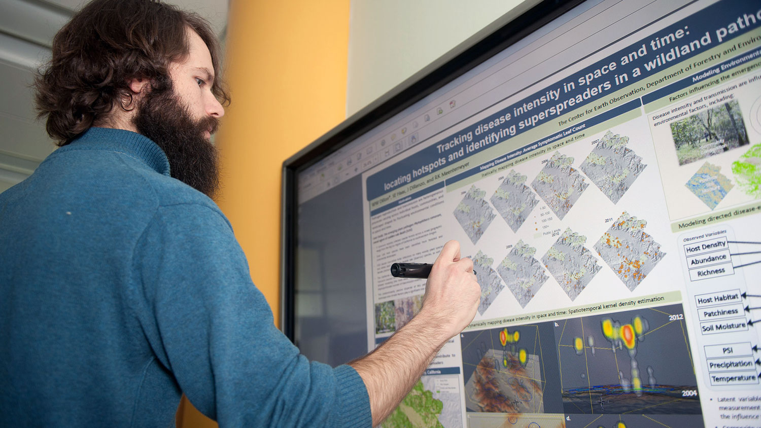 A student in the professional masters program using a touchscreen at the North Carolina State University Center for Geospatial Analytics