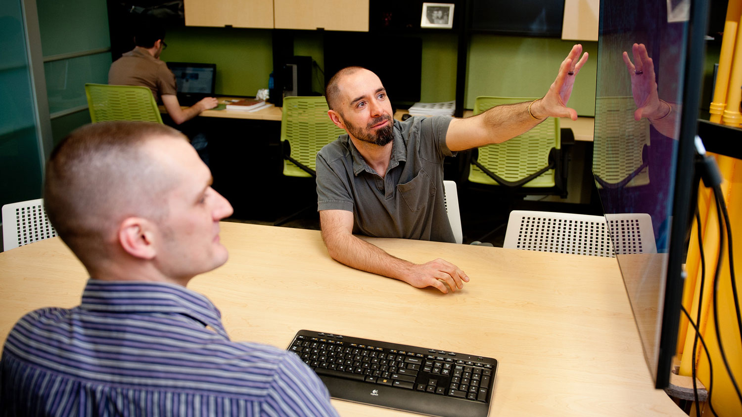 A photo of scholars in a graduate workroom at the North Carolina Center for Geospatial Analytics