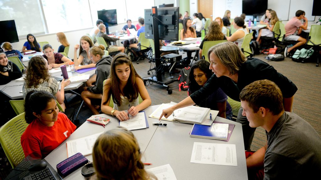 A photo of children in a classroom at the A photo of a user wearing an Oculus virtual reality headset at the North Carolina State University Center for Geospatial Analytics