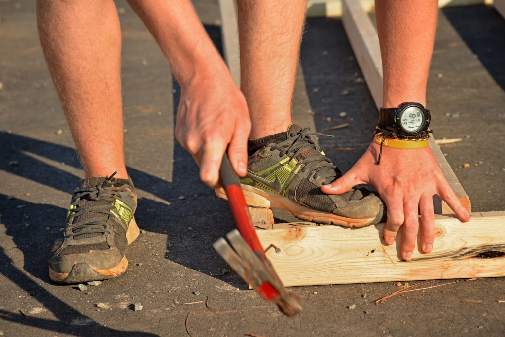 A photo of a student helping construct a new home for Habitat for Humanity.