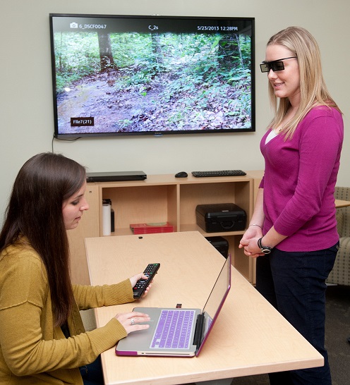 An image of two women conducting a geospatial 3-D visualization