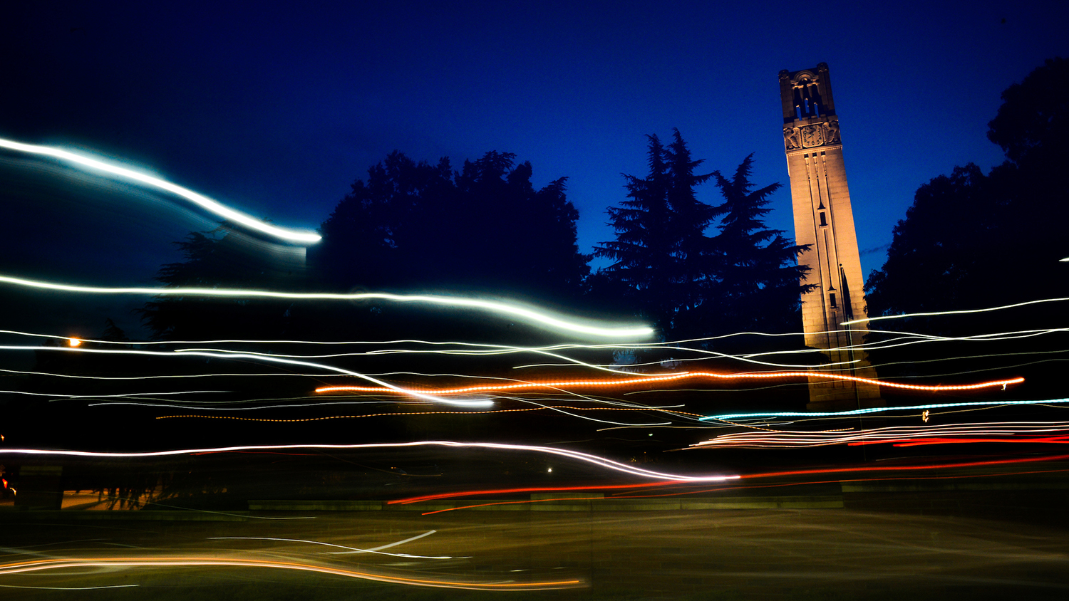 The NC State Belltower at dusk and night - Center for Geospatial Analytics at NC State University