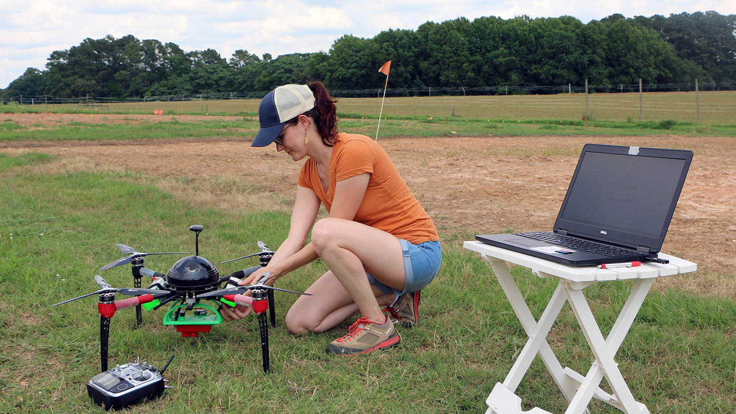A photo of a woman using a drone for the Center for Geospatial Analytics