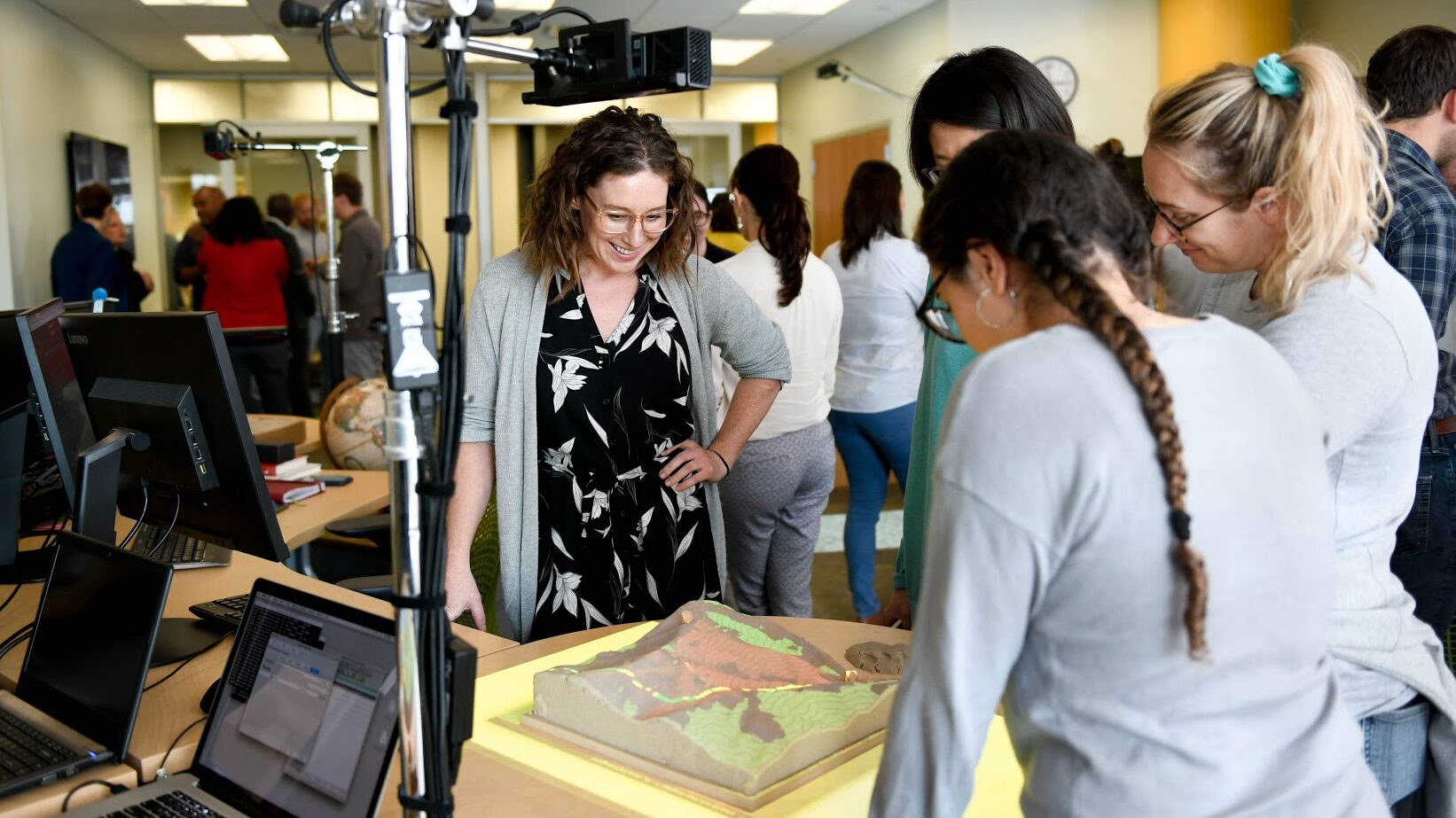 Nikki Inglis, center, greets guests at a Geospatial Analytics demonstration last year.