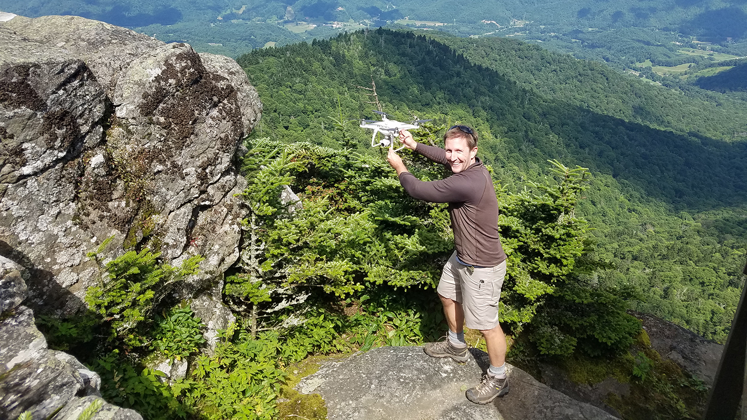 NC State University doctoral researcher Will Reckling prepares to launch a drone on Roan Mountain, NC, to map the area for endangered high-elevation plants - Keeping Track of Rare Mountaintop Plants with Drones - Center for Geospatial Analytics at NC State University