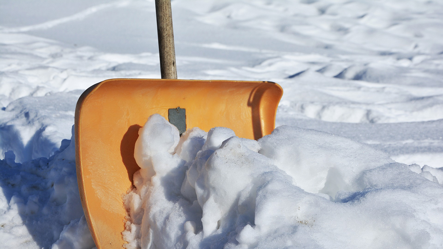 an orange snow shovel cuts through a pile of snow - New Visualization Tool Helps Weather Forecasters and Researchers More Easily Identify and Study Bands of Heavy Snow - Geospatial Analytics at NC State University