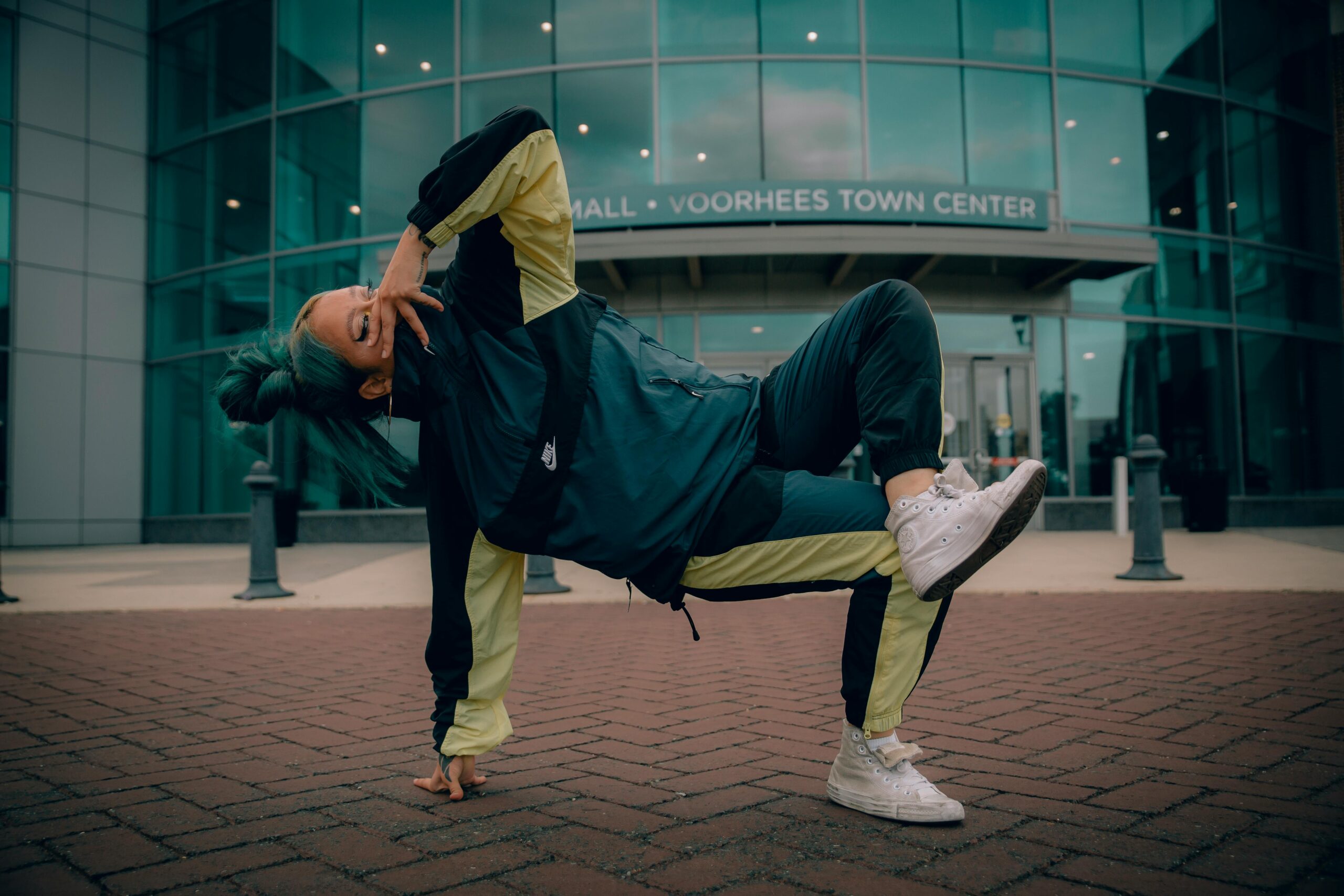 Woman breakdancing on pavement