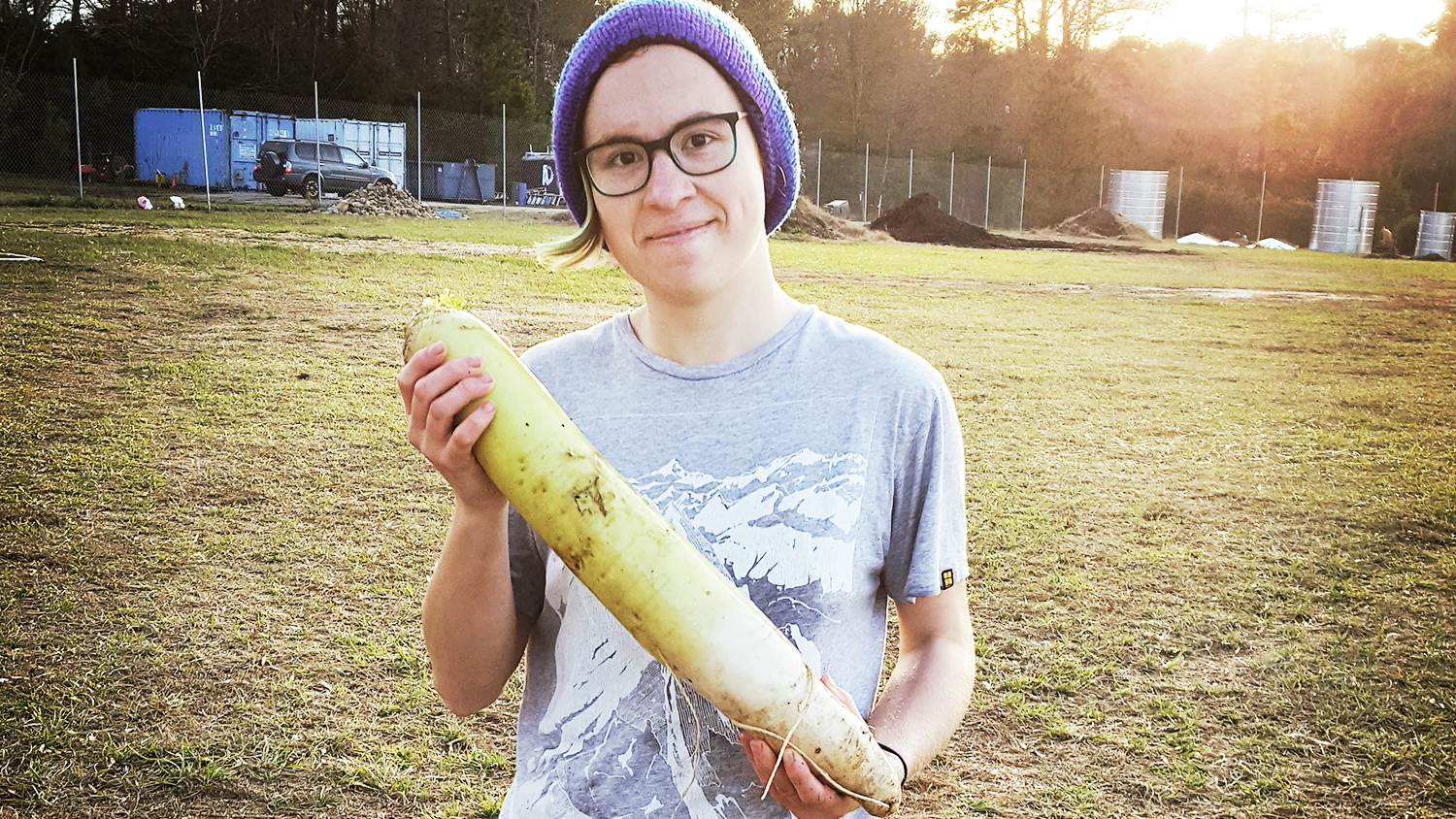 Matthew Adkins holding a daikon radish