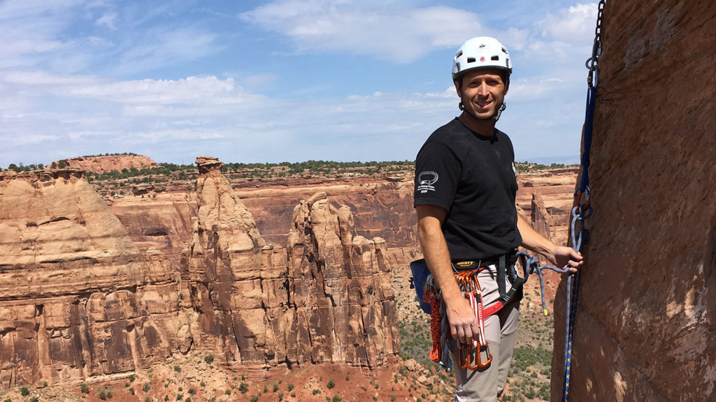 Student poses while climbing