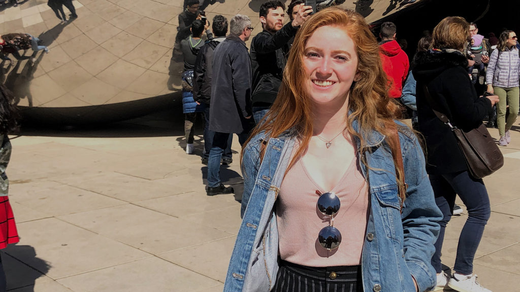 Student poses at the Bean in Chicago