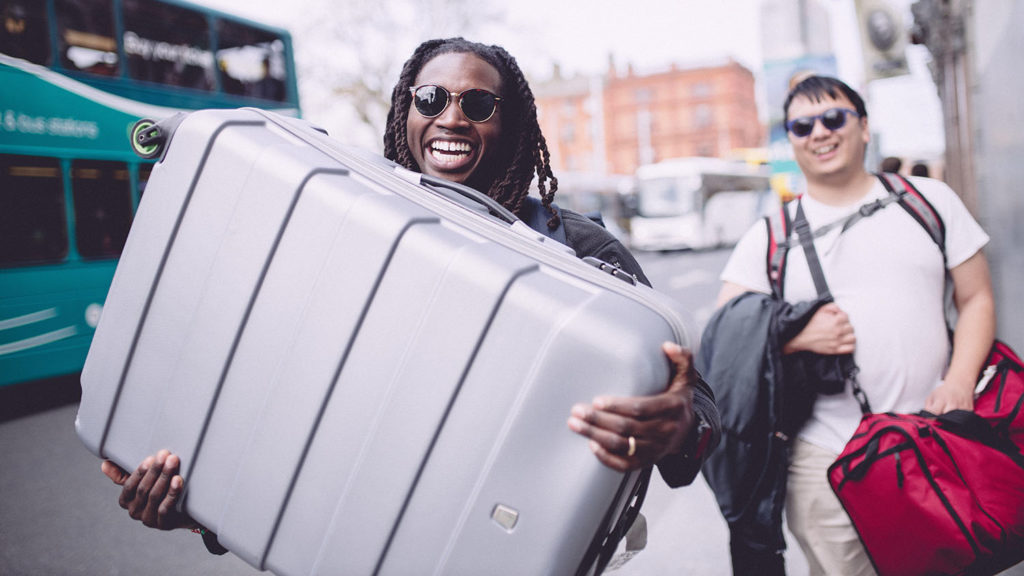 Student holding broken luggage in Dublin