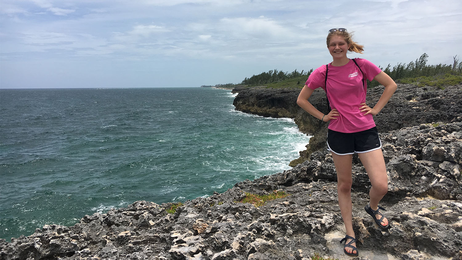 Jenny poses by the ocean