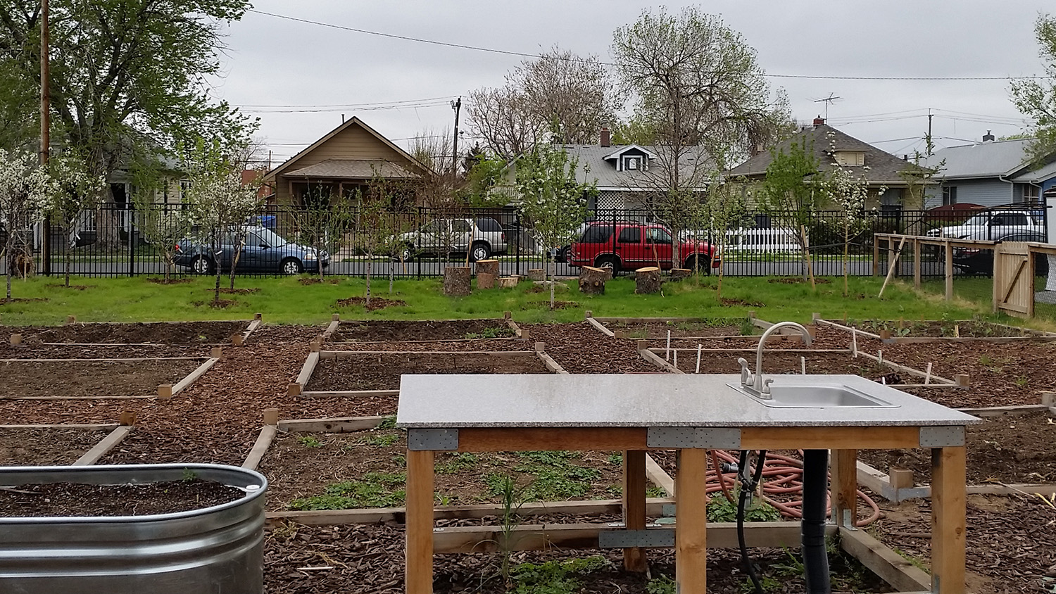 work table and garden plots in a large fenced-in area