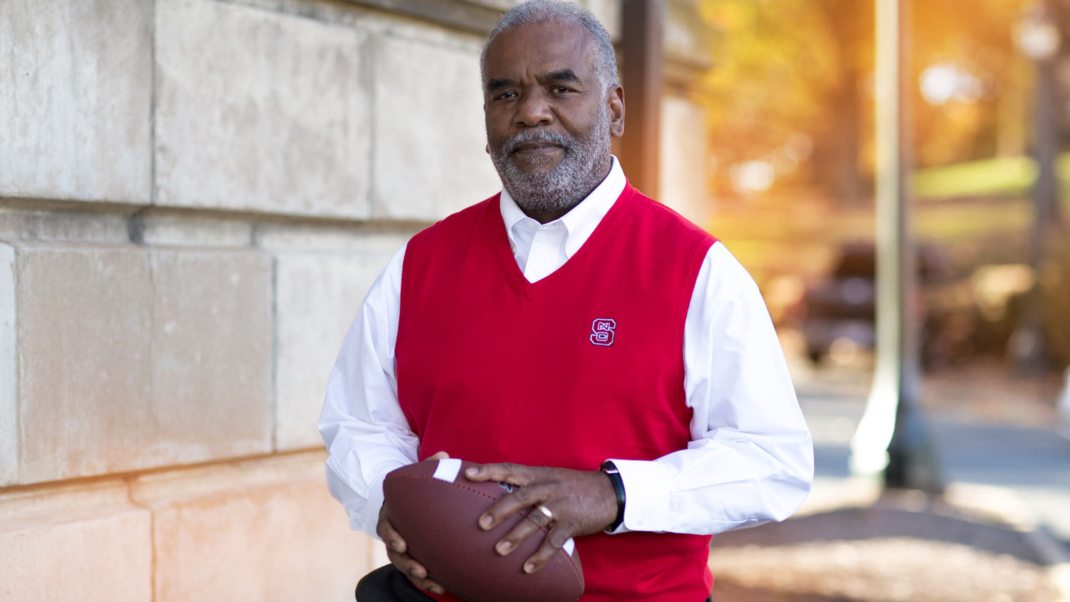 Marcus Martin Holding a Football - Marucs Martin Named Distinguished Alumnus of the Year - College of Natural Resources News NC State University