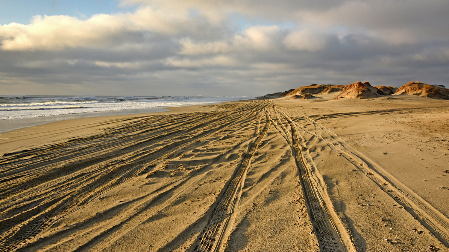 Tracks run along the sandy beach on the "road" to Carova.
