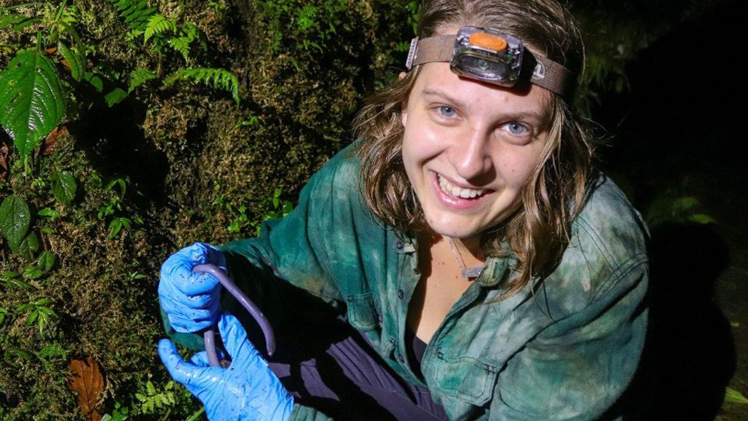 NC State student LP Mancini holds a caecilian in the Amazon rainforest - What It's Like to Study Tropical Wildlife in South America - College of Natural Resources News - NC State University