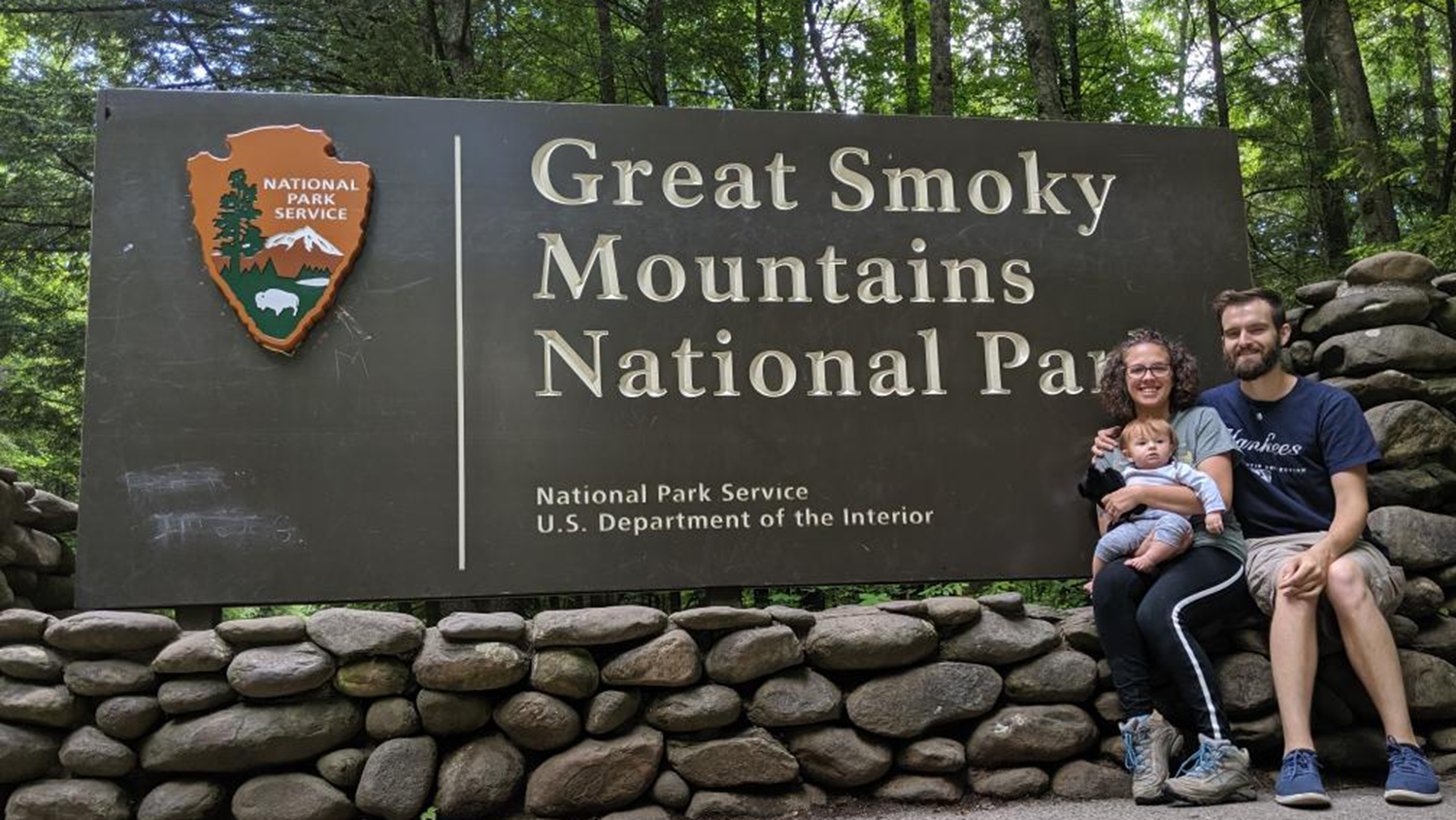 Austin and family in front of Great Smoky Mountains National Park sign