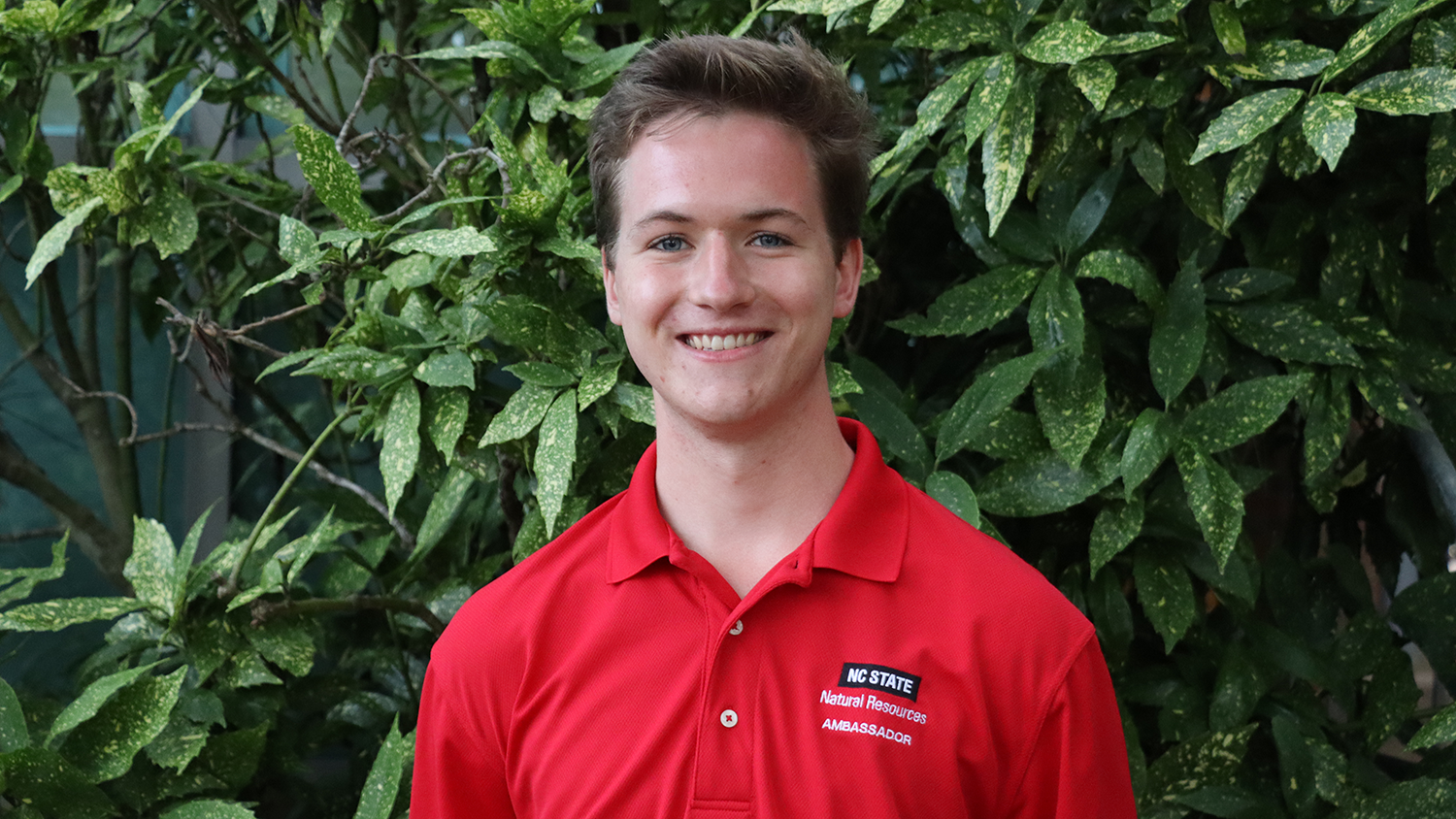 Melzer Morgan standing in front of greenery - 5 Questions with Campus As A Classroom Intern Melter Morgan - College of Natural Resources News NC State University