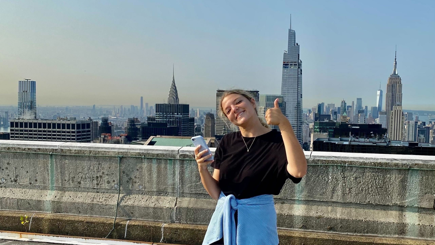 Kamila stands in font of the New York City skyline - 5 Questions with Prescriptive Data Account Manager Kamila Edwards - College of Natural Resources News NC State University