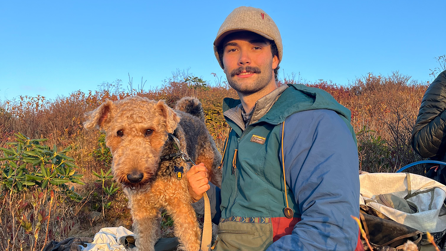 Houston Bumgarner and his dog, Chewie, sitting at Black Balsam Knob - Graduation to Vocation: Houston Bumgarner is Protecting California's Wildlife - College of Natural Resources News NC State University