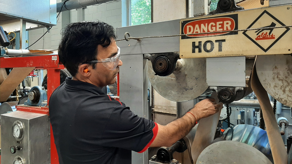 NC State professor Lokendra Pal operates the pilot plant paper machine at the Paper and Pulp Testing Laboratory - NC State to Lead $10M Initiative to Decarbonize Forest Products Industry - College of Natural Resources News - NC State University