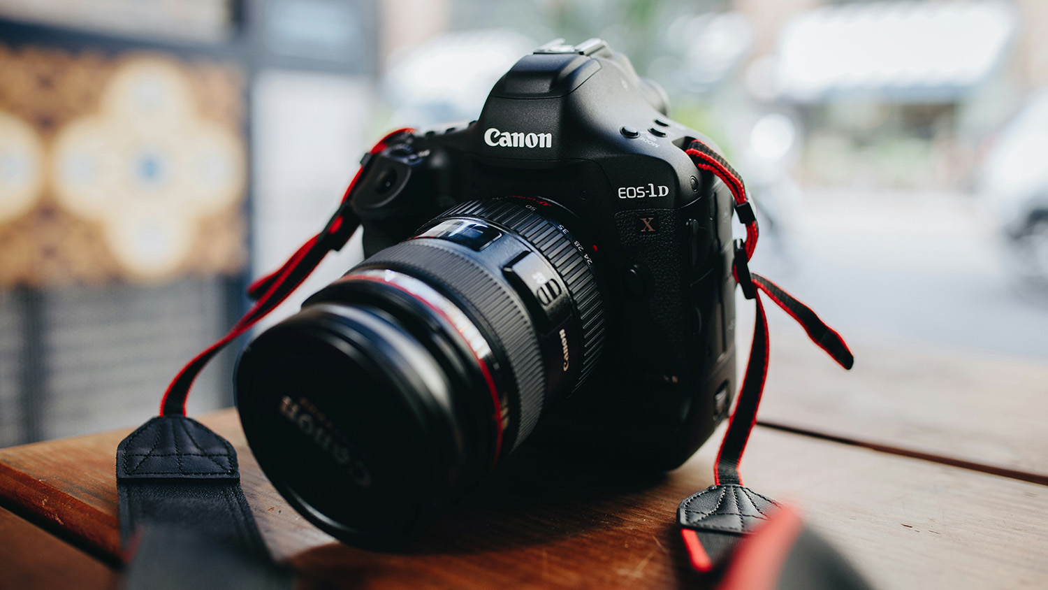 Close-up of a digital camera on a desk.