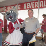 Ronnie Hise laughs while posing with Mrs. Wuf