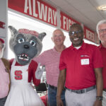 Dean Myron Floyd and Mrs. Wuf pose with three donors