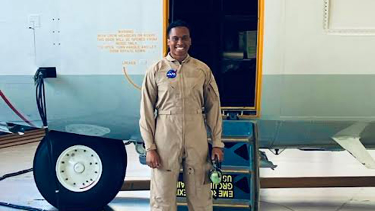 Brandon Wilson standing in front of a NASA aircraft.