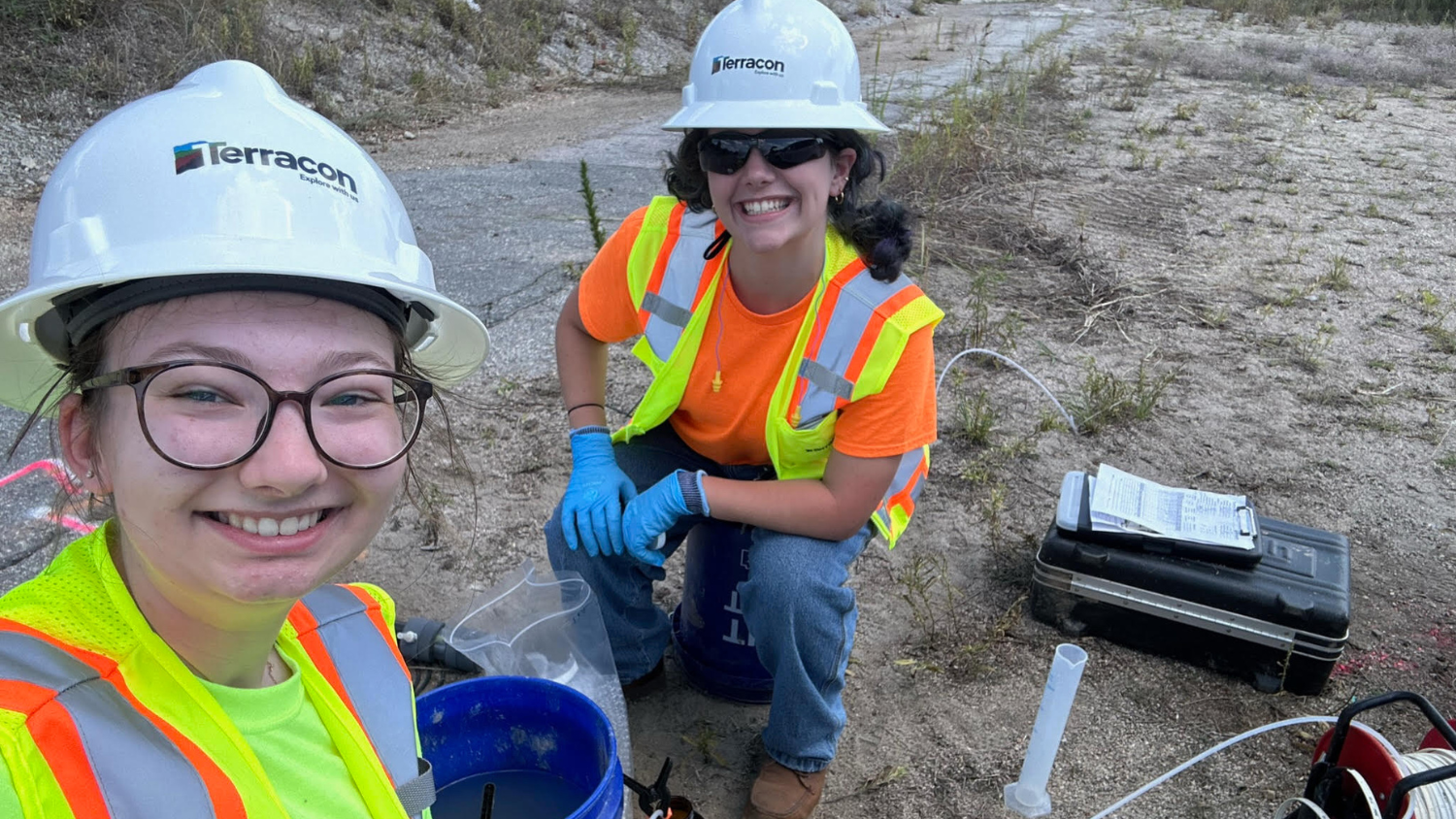 Sydney and Cecilia pose in hard hats at Terracon