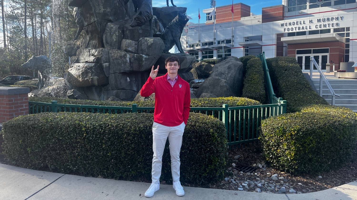 Banks poses in front of stadium