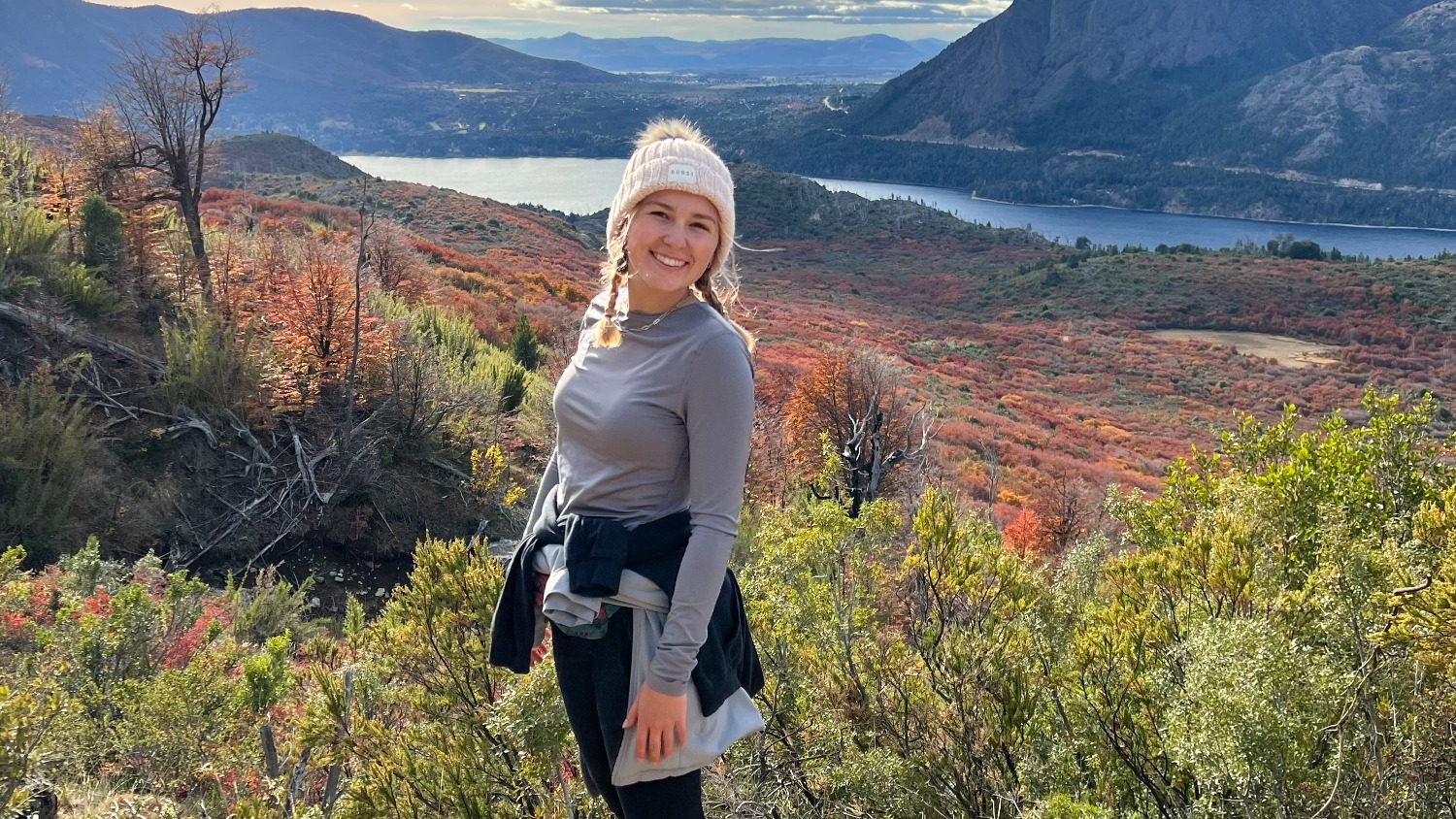 Emily poses in front of mountain landscape.