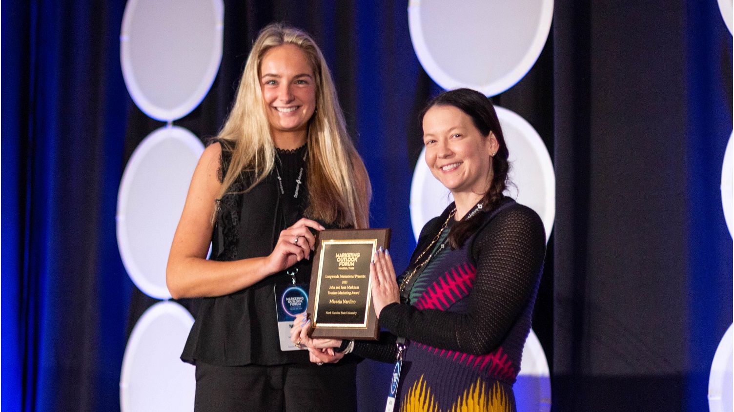 Micaela with her plaque - Micaela Nardino Receives Marketing Award from Travel and Tourism Research Association - Parks Recreation and Tourism Management NC State University