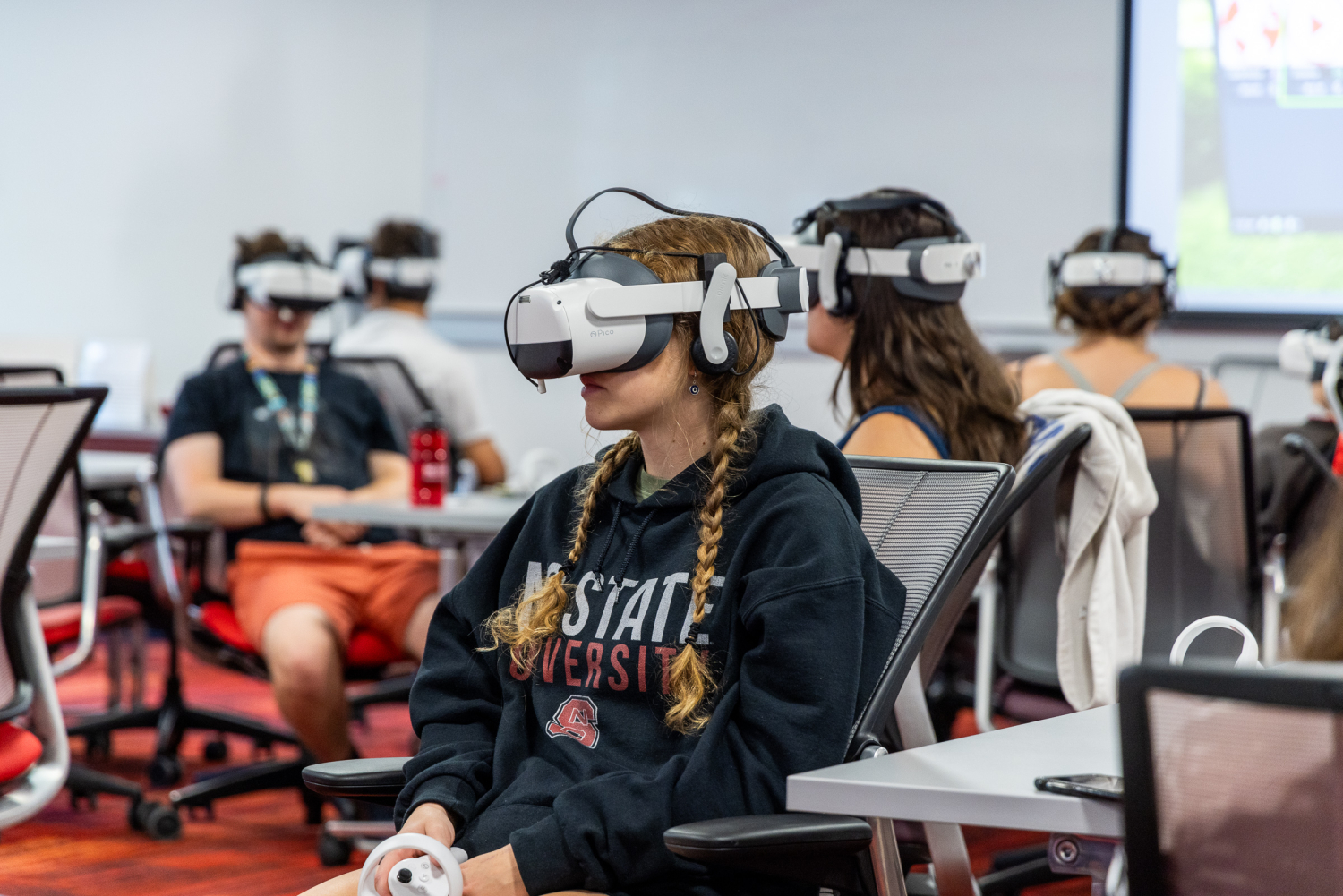 A student in a classroom wears a virtual reality headset - Immersive VR Tours Promote Inclusive Recreation - Parks, Recreation and Tourism Management at NC State University
