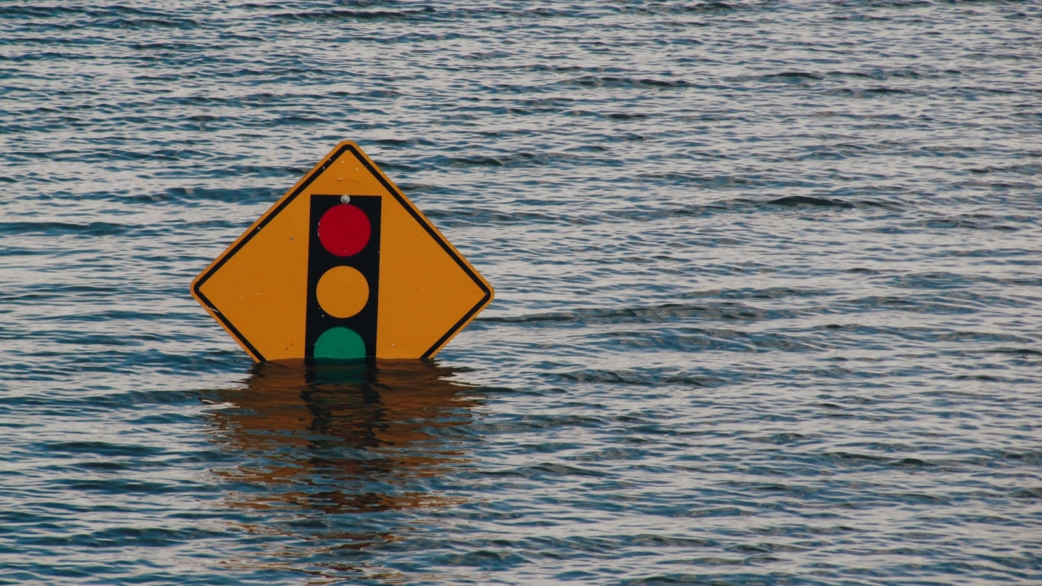 A traffic sign submerged in water.