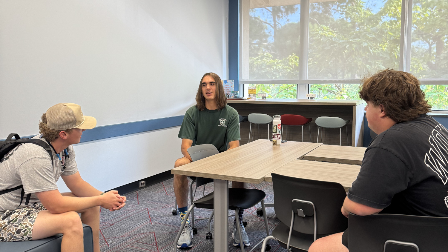 Three students conversing in a classroom. - Admissions - College of Natural Resources at NC State