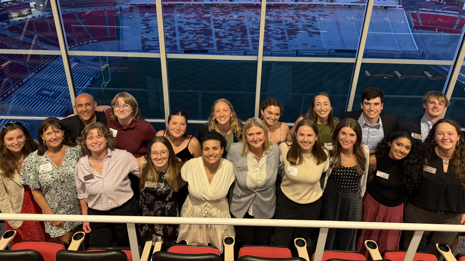 Group photo in front of a wide wall of windows - College of Natural Resources at NC State University