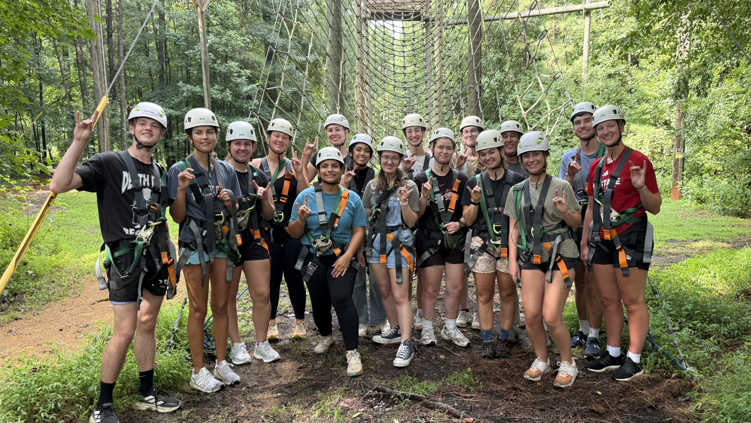 Group picture of students in hardhats and safety gear at a ropes course. - College of Natural Resources at NC State University